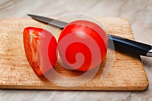 Ripe tomato cut segment on board
