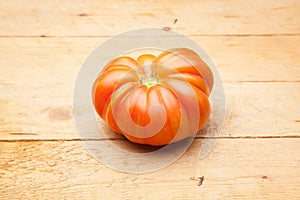 Ripe tomato on wooden background