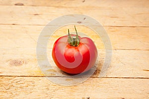 Ripe tomato on wooden background