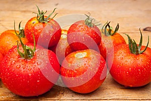 Ripe tomato on wooden background