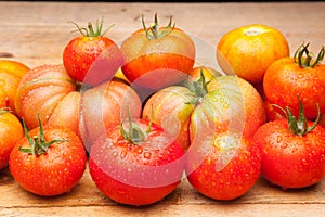 Ripe tomato on wooden background