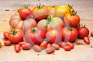 Ripe tomato on wooden background