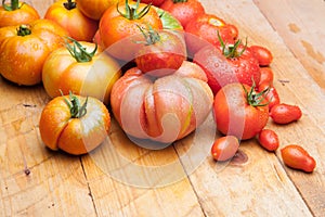 Ripe tomato on wooden background