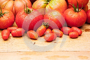 Ripe tomato on wooden background