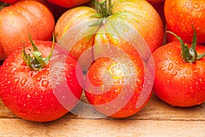 Ripe tomato on wooden background