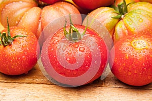 Ripe tomato on wooden background