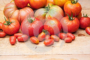 Ripe tomato on wooden background