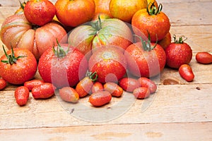 Ripe tomato on wooden background