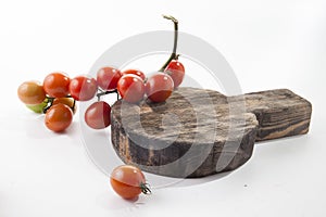 Ripe tomatoes on lie on a cutting board on a white background,,