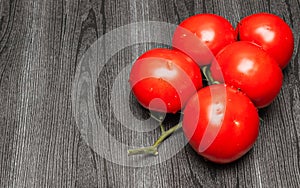 Ripe tomatoes on a twig.