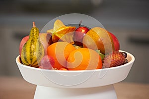 Ripe tropical fruits in a white dish