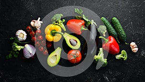 Ripe vegetables. Fresh vegetables on black stone background. Tropical fruits. Top view.