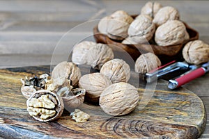 Ripe walnuts on the wooden kitchen table closeup. Walnuts fruit on the wooden cutting board