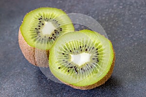 Ripe whole kiwi fruit and half kiwi fruit isolated on vintage ba