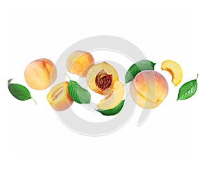 Ripe whole and sliced peaches with leaves close up in the air isolated on a white background