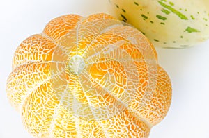 Ripe yellow melon close up on white background, texture pattern of the rind