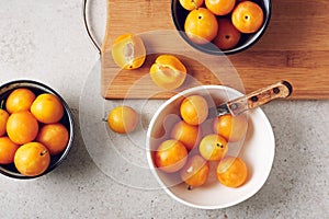 Ripe yellow mirabelle plums in bowls