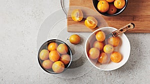 Ripe yellow mirabelle plums in bowls