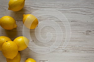 Ripe Yellow Organic Lemons on a white wooden background, top view. Flat lay, overhead, from above. Copy space