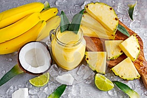 Ripe Yellow Pineapple, coconut, Smoothie with slices of Lime and ice. concept healthy food.