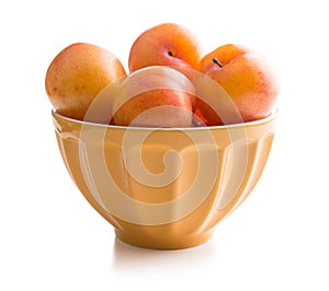 Ripe yellow plums in bowl.