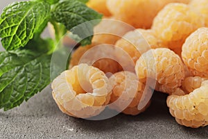 Ripe yellow raspberries on a marble background