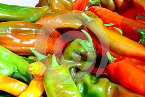 Ripe Yellow, Red and Green Peppers in Vegetables Market