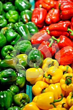 Ripe Yellow, Red and Green Peppers in Vegetables Market