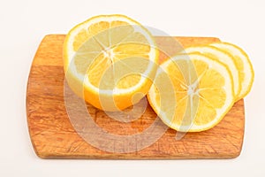 Ripe yellow sliced lemon on a Board on a white background. Close up