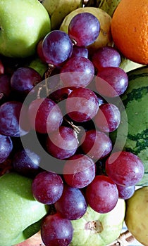 Ripen grapes on a fruit basket