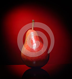 Ripen pear isolated on red background photo