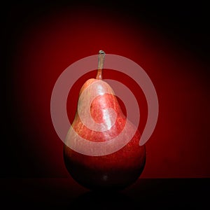 Ripen pear on red background