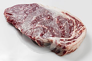 Ripened seasoned beef rump or striploin steak on white background