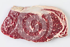 Ripened seasoned beef rump or striploin steak on white background isolated photo