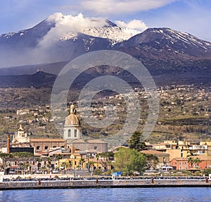 Riposto e  il vulcano Etna sullo sfondo vista dal porto marittimo della cittadina photo