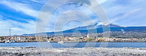 Porto di Riposto e l\'Etna sullo sfondo vista dal mare durante giornata estiva con barche e chiesa del porto photo