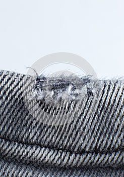 Ripped Grey hipster jeans material. Destroyed denim Gray Cloth texture. Close up