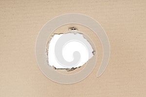 Ripped hole in cardboard on white background with clipping path