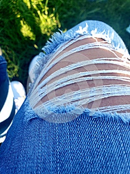 Ripped knee in blue jeans