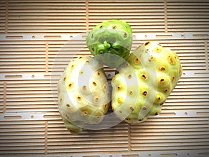 Ripped noni friuts isolated