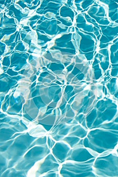 Ripped water in swimming pool. Surface of blue swimming pool, background of water.