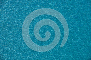 Ripped water in swimming pool. Surface of blue swimming pool, background of water.