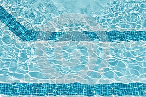 Ripple Clear Blue Water in Swimming Pool with Sun Reflection