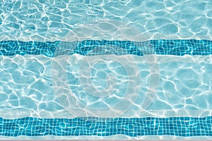 Ripple Clear Blue Water in Swimming Pool with Sun Reflection