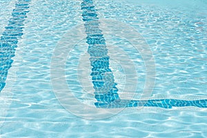 Ripple Clear Blue Water in Swimming Pool with Sun Reflection