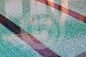 Ripple Water in swimming pool with sun reflection.