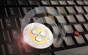 Ripple XRP  coin over a black laptop keyboard