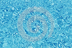 Rippled pattern of clean water in a blue swimming pool