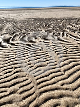 Rippled sand along the shore by Salt Flats In Sonora, Mexico