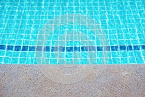 Rippled surface of Swimming pool blue water sun reflecting sleek background